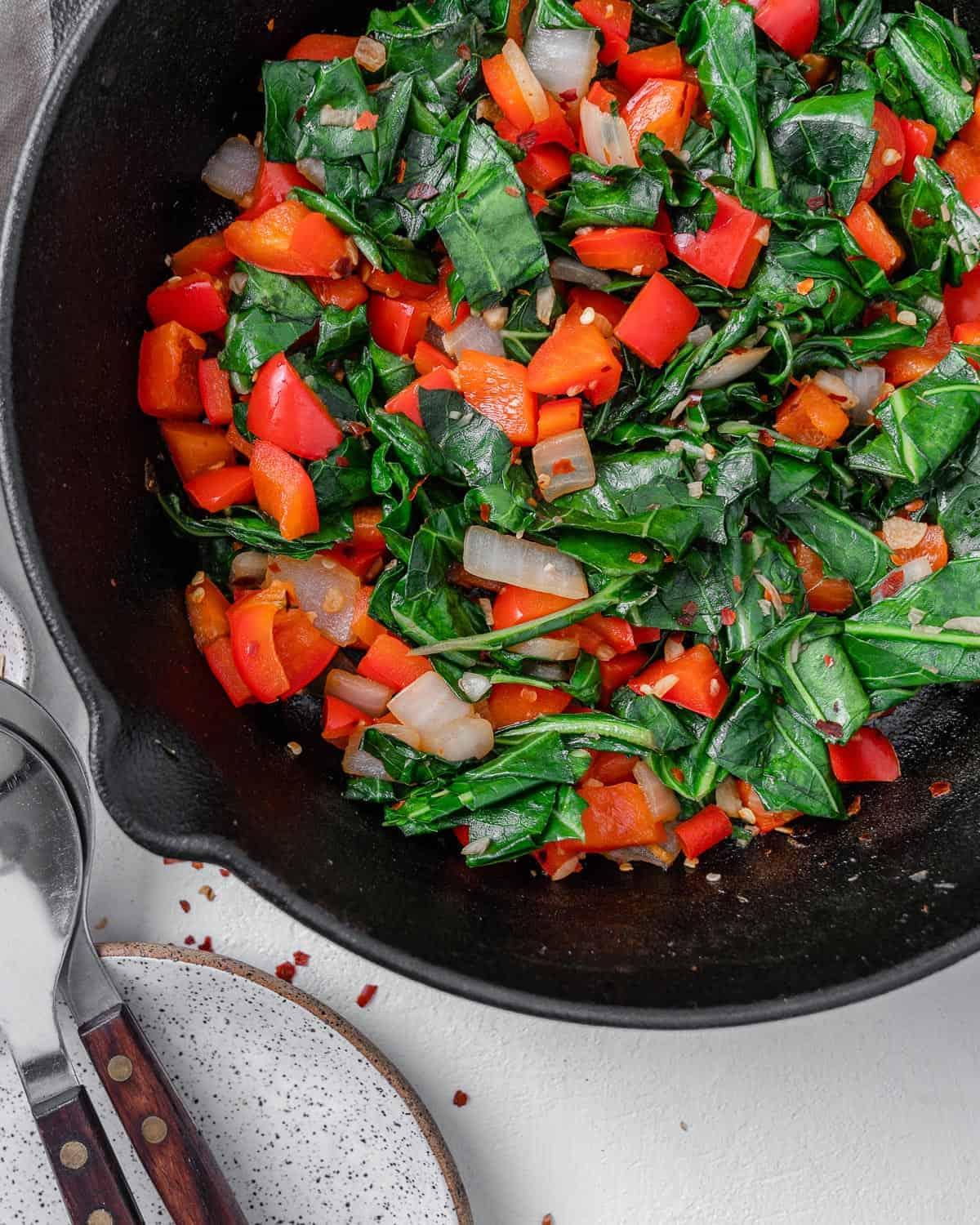Scharfer Blattkohl 2 completed Spicy Collard Greens in a black pan against a white surface