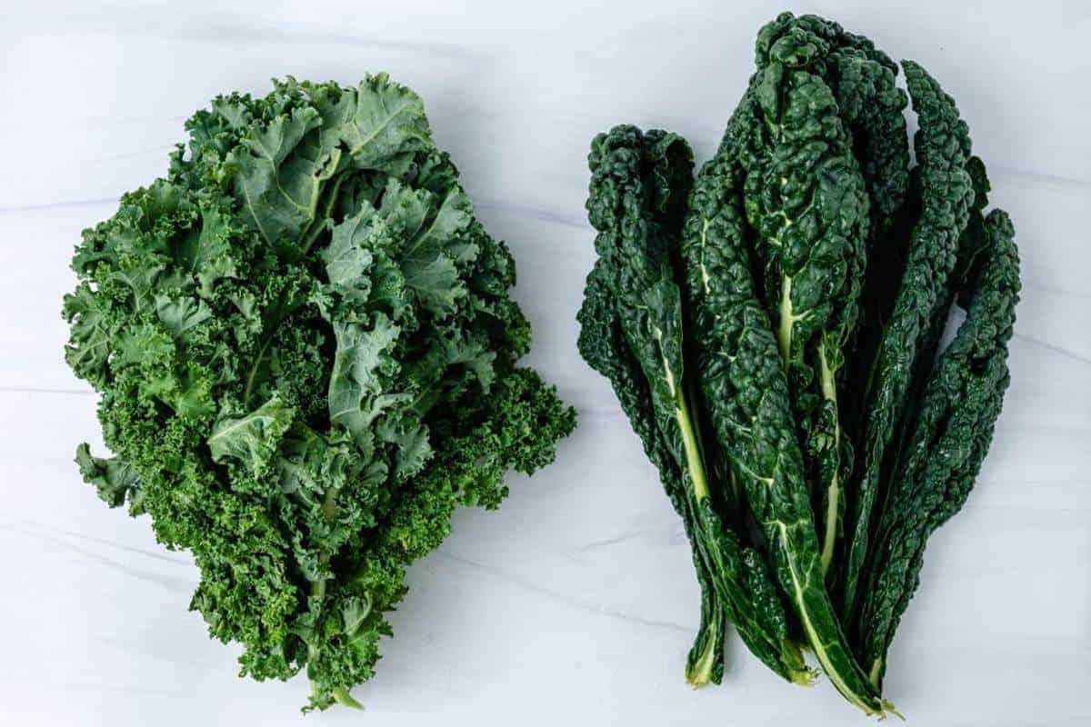 Dino Kale and Curly Kale on a Marble Surface 