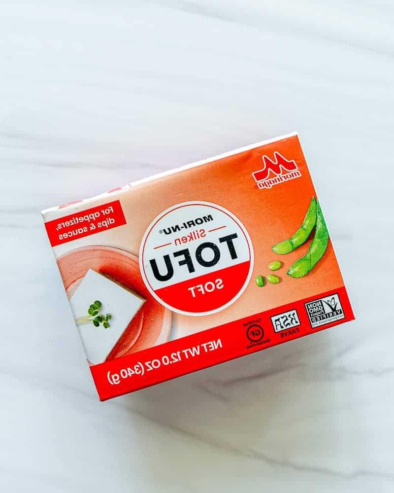 Vier verschiedene verpackte Tofu-Blöcke auf weißem Hintergrund, die die Vielfalt und Verfügbarkeit von Tofu im Handel zeigen.