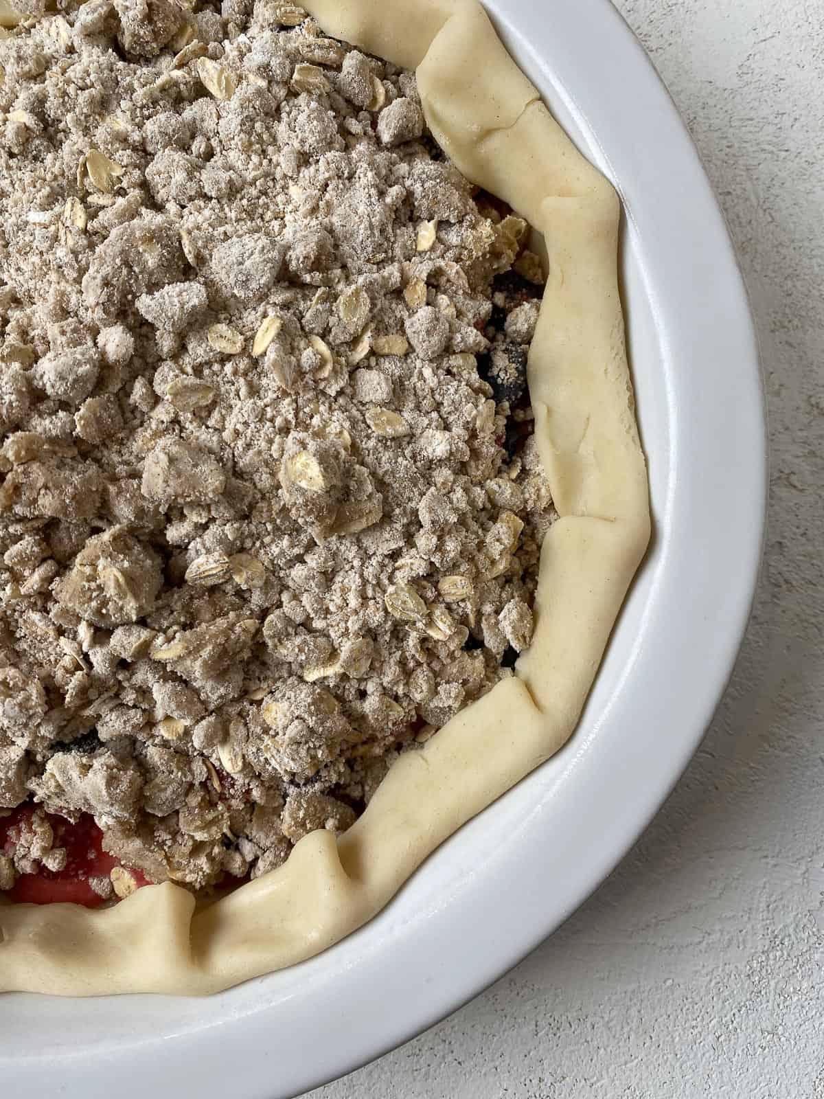 pre-baked close up of Mixed Berry Crumb Pie in pie dish