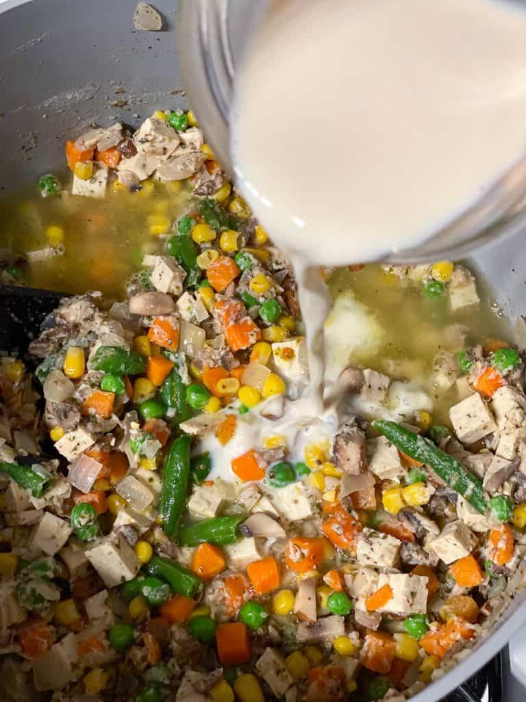process shot of milk being added to pan