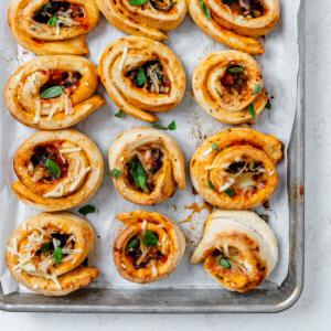 Vegane Pizzaröllchen 19 several completed vegan pizza rolls on a baking dish