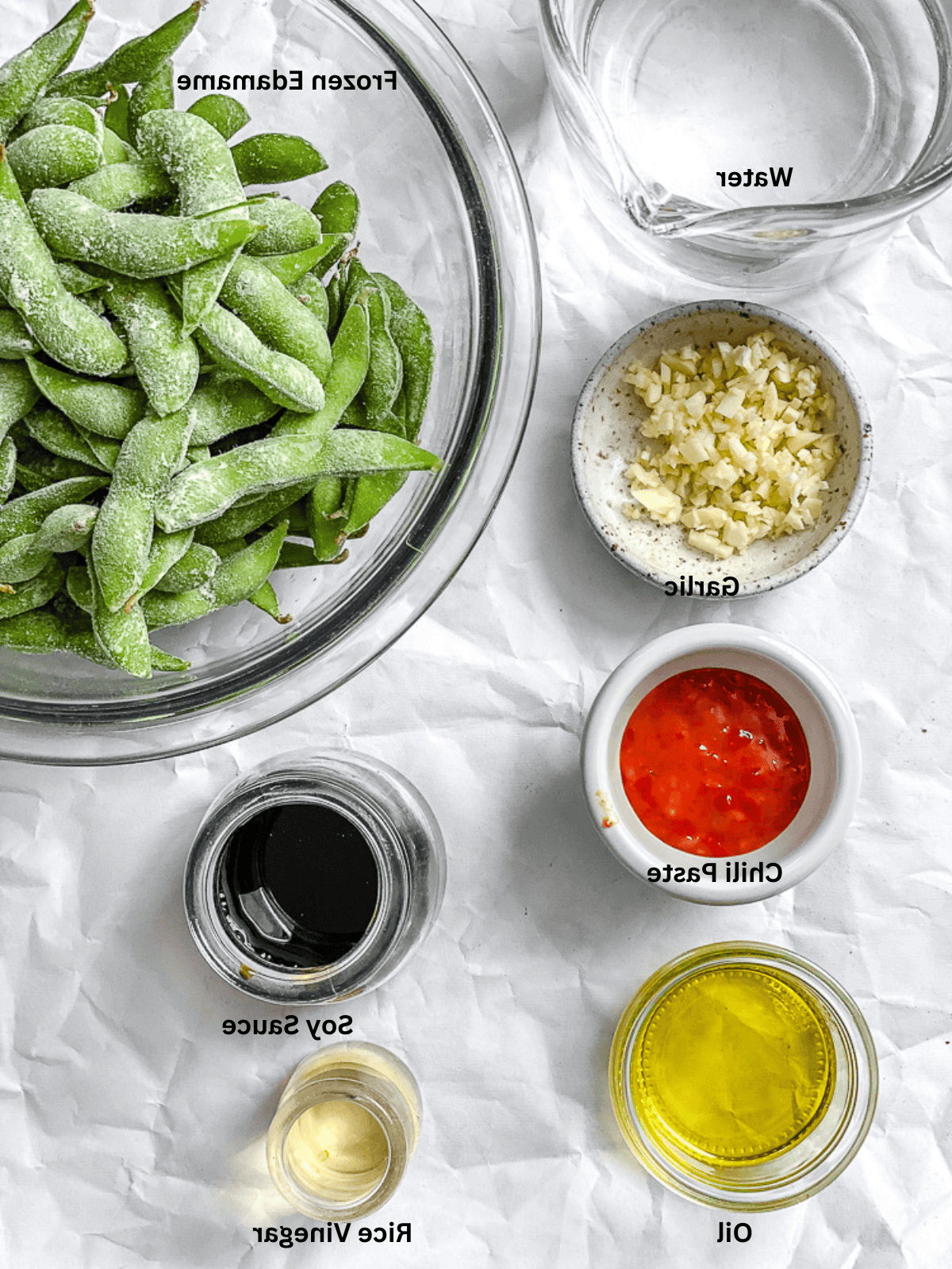 ingredients for Quick Spicy Edamame [Chili and Garlic] measured out on a white surface