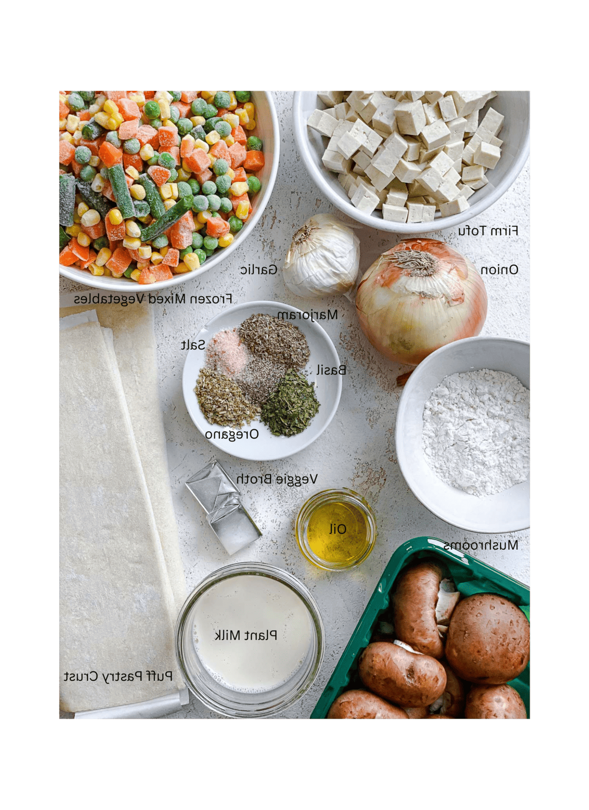 ingredients for Mixed Vegetable Vegan Pot Pie measured out against a white surfaceA