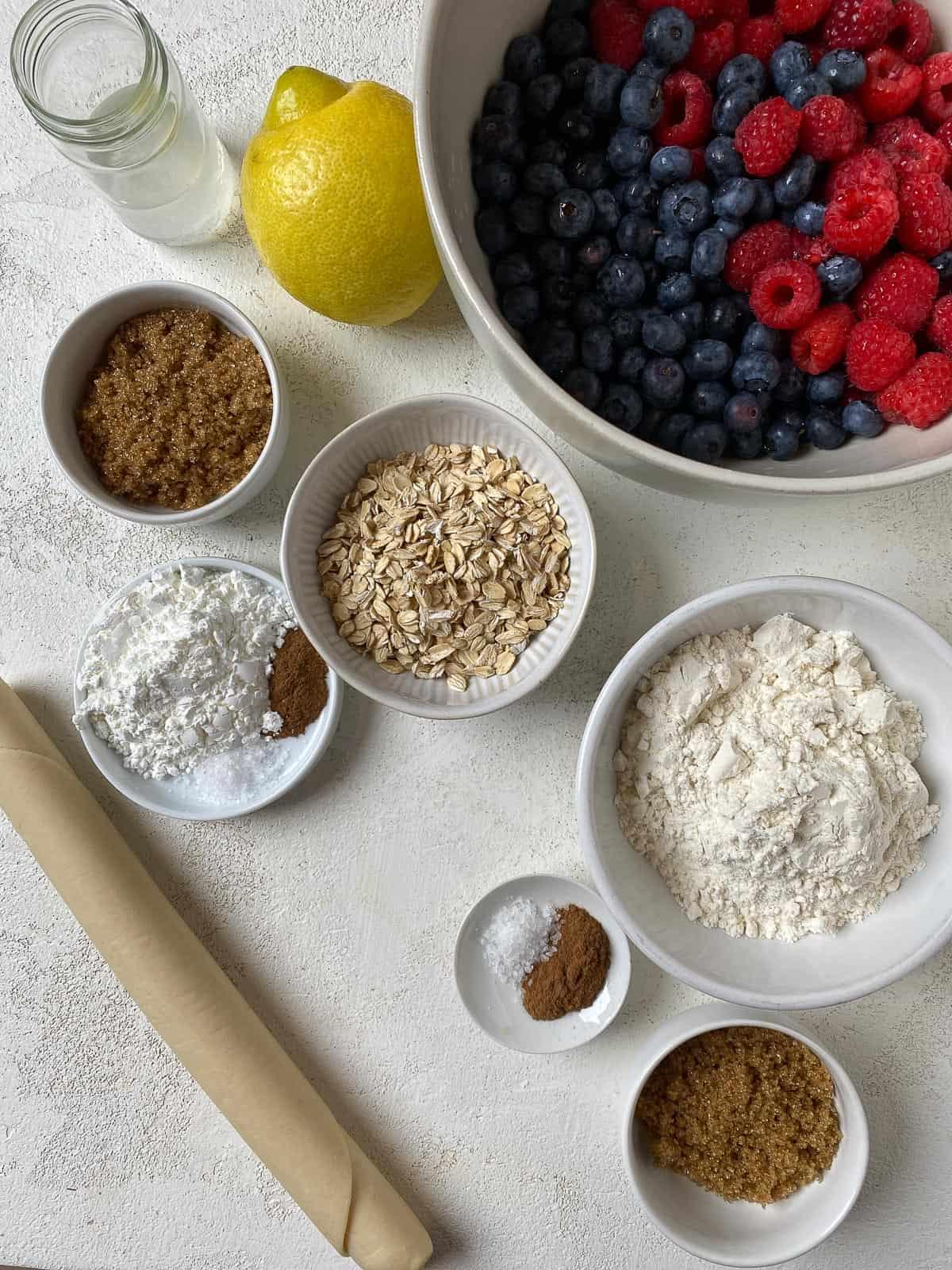 ingredients for Mixed Berry Crumb Pie measured out on a white surface