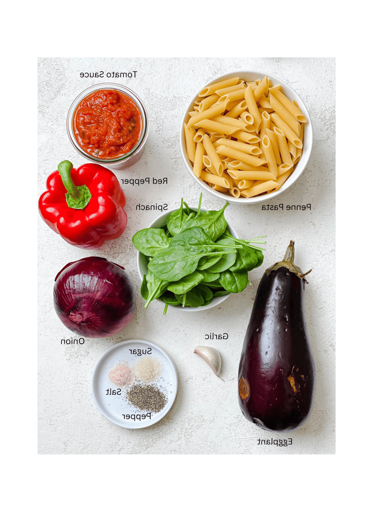 Einfache Penne alla Norma (Auberginenpasta) 3 ingredients for Easy Penne Alla Norma (Eggplant Pasta) measured out against a white surface