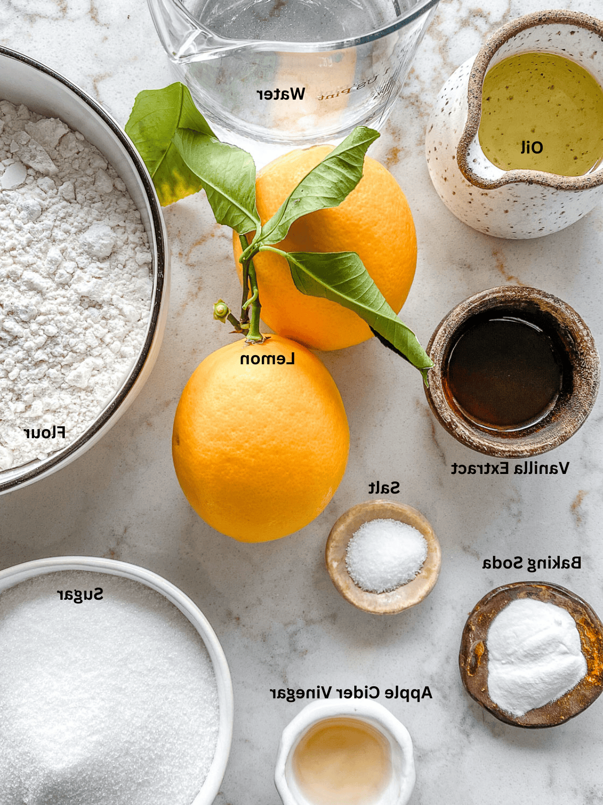 Einfache Vegane Zitronen Cupcakes 3 ingredients for Lemon Vanilla Cupcakes measured out on a white surface