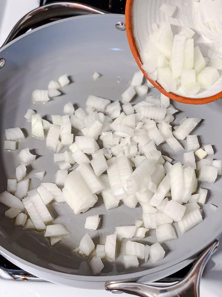 Curry-Kichererbsen 4 Prozessaufnahme: Zwiebeln werden in einer großen Pfanne angebraten.