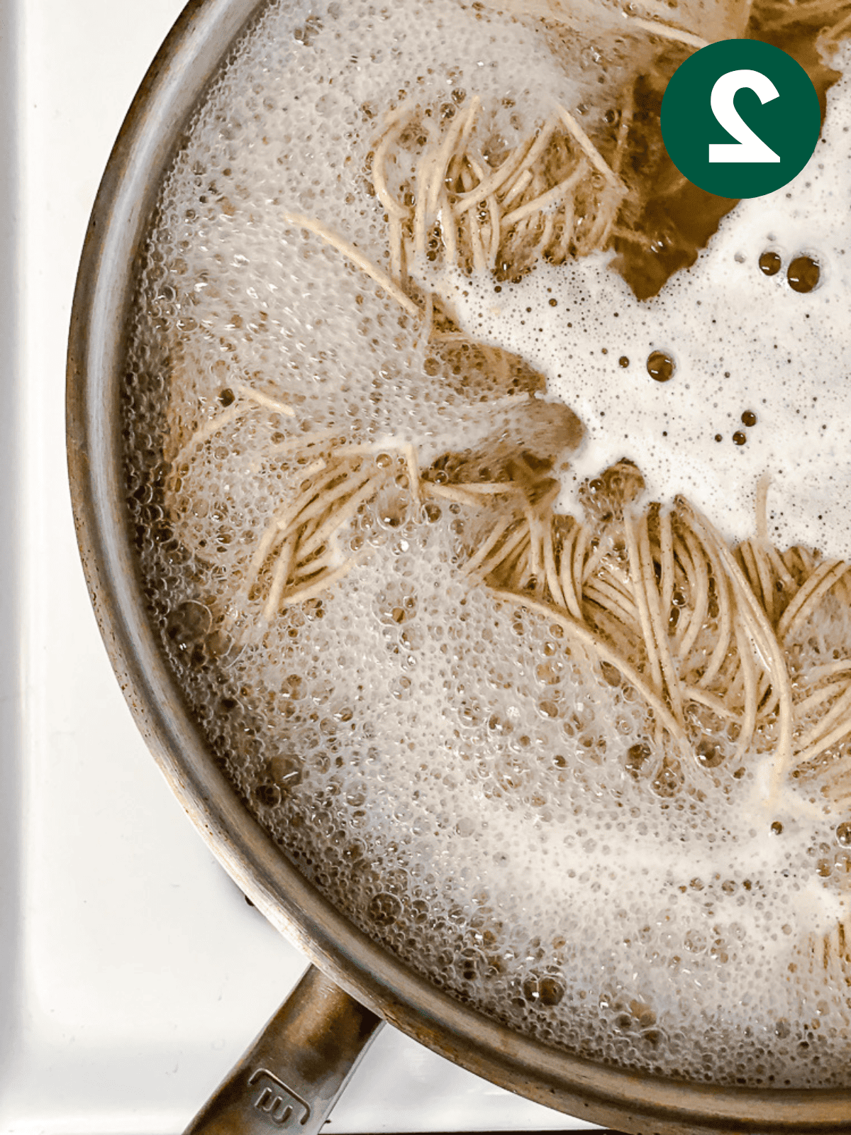 boiling soba noodles in a pot of water.