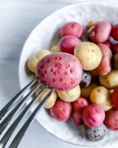 close up of raw Roasted Rosemary Potatoes in a white bowl
