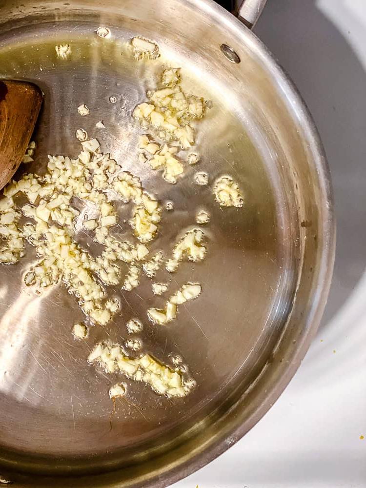 process shot showing garlic cooking in pan