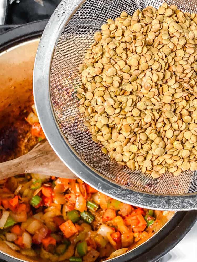 process shot of adding lentils to pot