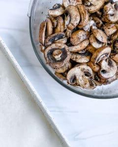 post mixing of spices and mushrooms in a white bowl