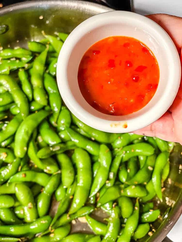 process shot showing adding chili paste to pan