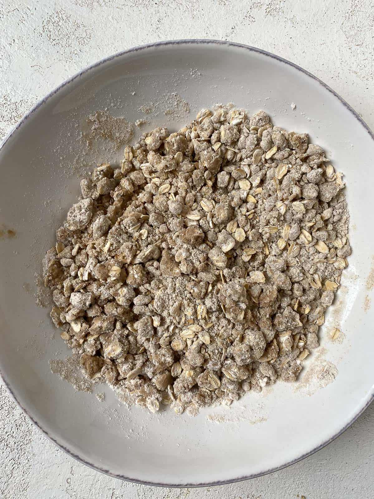 post mixing of crumble topping in a white bowl