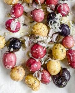 process of making Roasted Rosemary Potatoes against white parchment paper