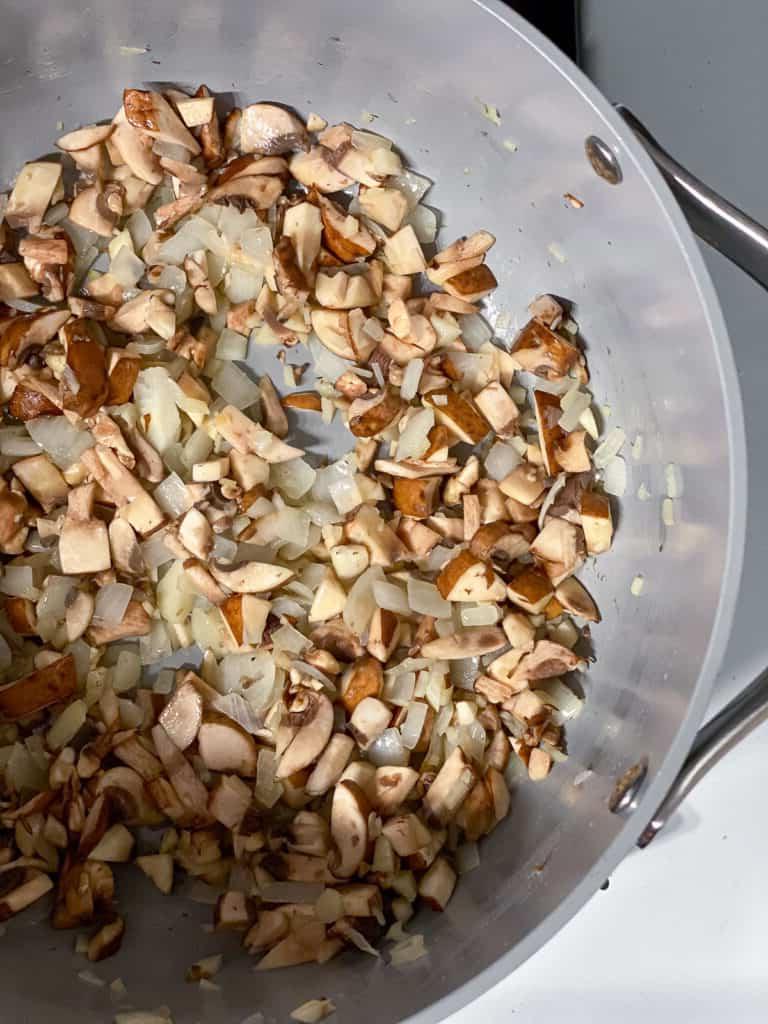 process shot showing ingredients cooking in pan