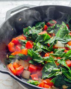 Scharfer Blattkohl 9 process of vegetables being cooked in black skillet