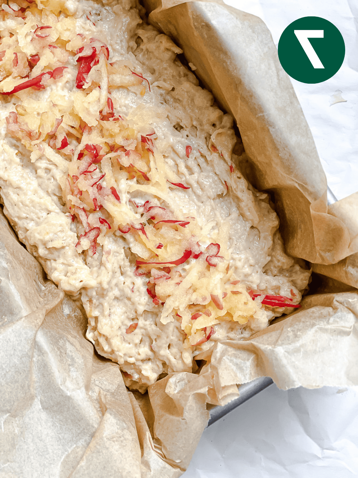 Apfel-Zimt-Brot 10 Ungebackenes Apfel-Zimt-Brot, belegt mit geriebenen Äpfeln in einer Kastenform.