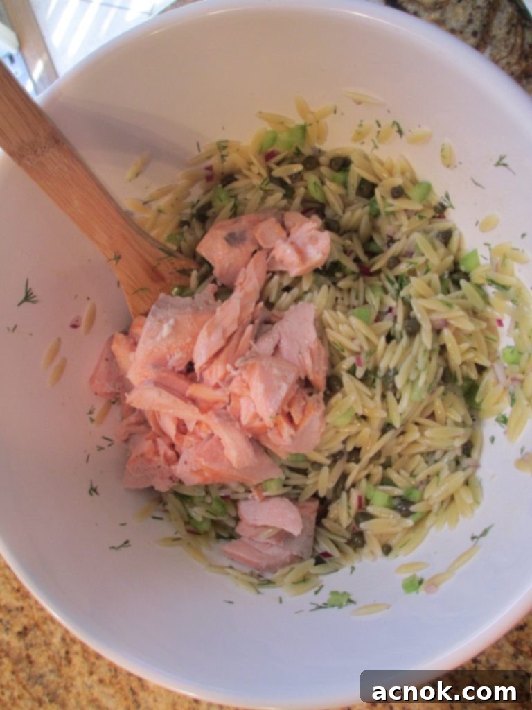 The Salmon Caper Orzo Salad with flaked salmon, orzo, and fresh ingredients gently mixed.