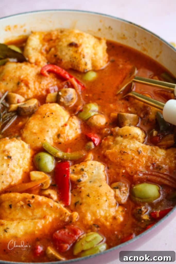 close up of chicken cacciatore, beautifully plated with herbs