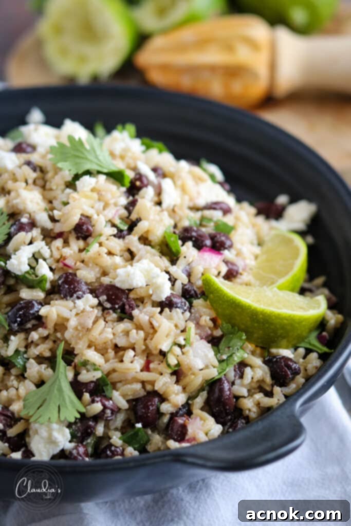 brown rice black bean salad with feta close up in black bowl
