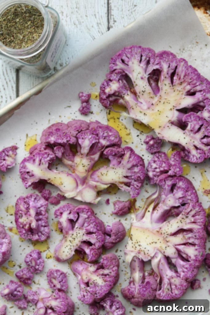 Purple Cauliflower on baking sheet seasoned with Herbes de Provence
