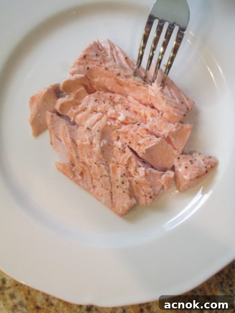 flaking poached salmon