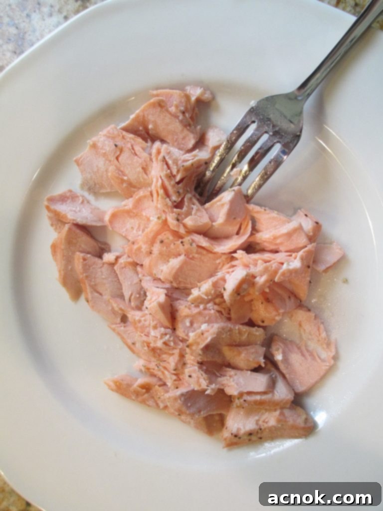 flaking poached salmon into large pieces