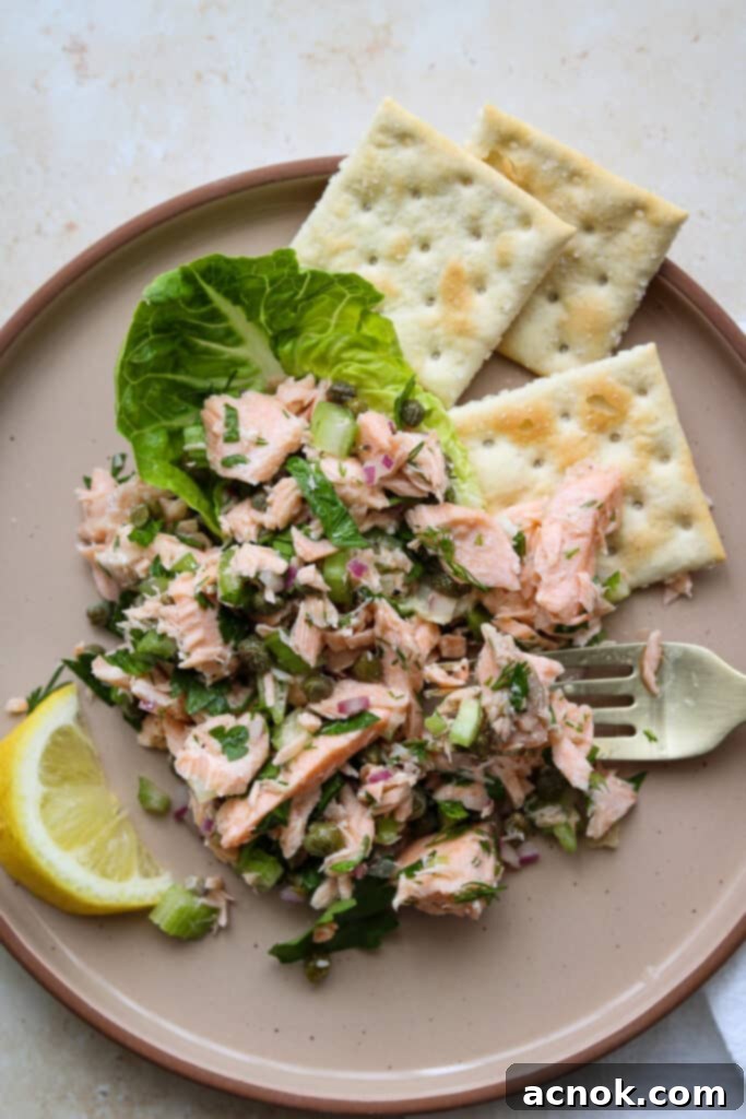 chilled poached salmon salad on plate with crackers
