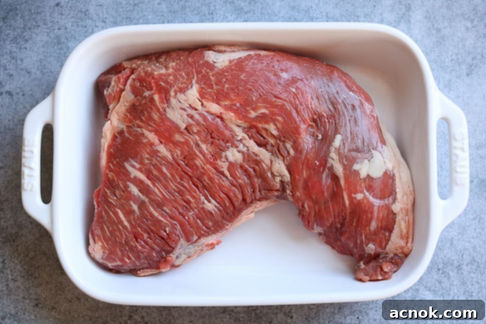 raw tri tip in dish ready to be marinated