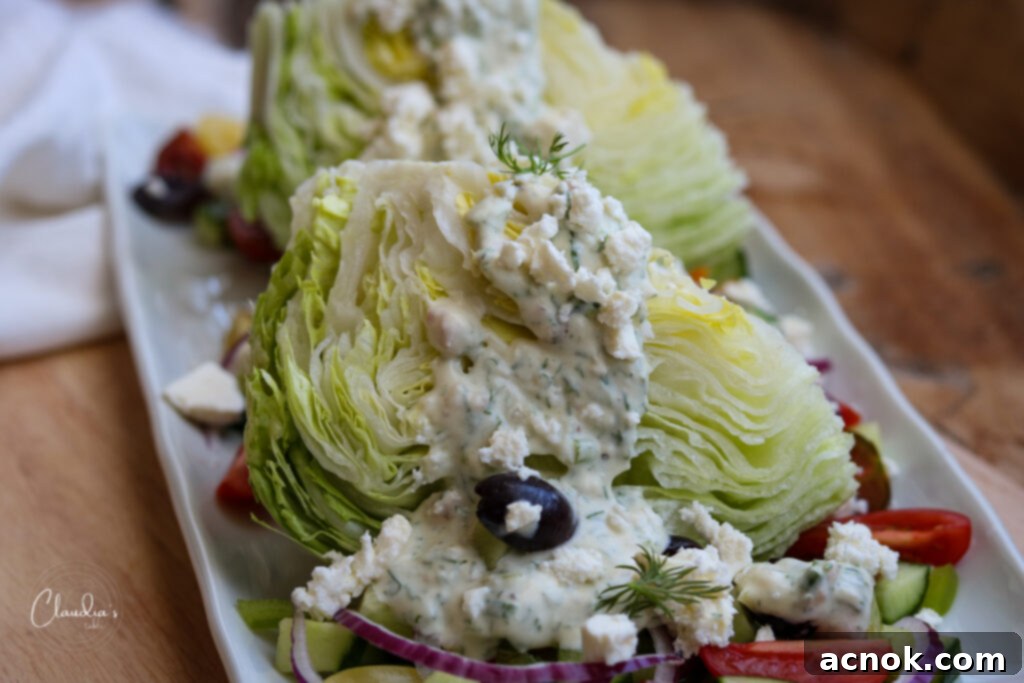 wedge salad with toppings on white plate with napkin 