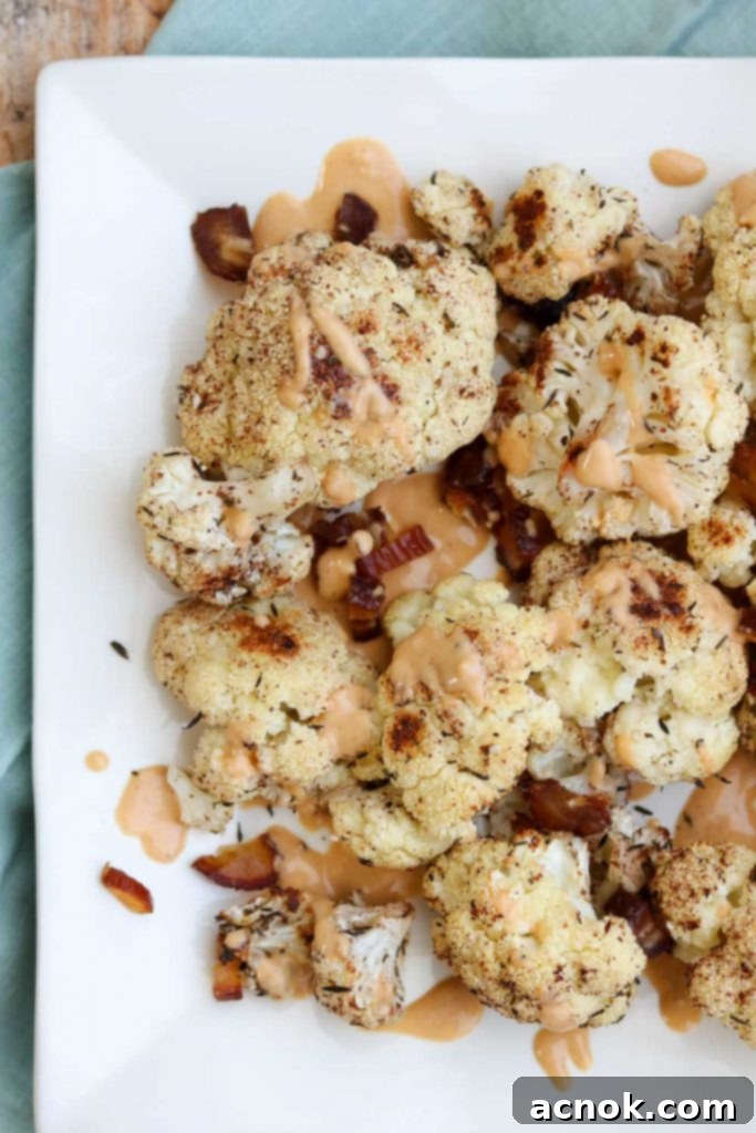 Plated roasted cauliflower with sauce and dates, ready to serve