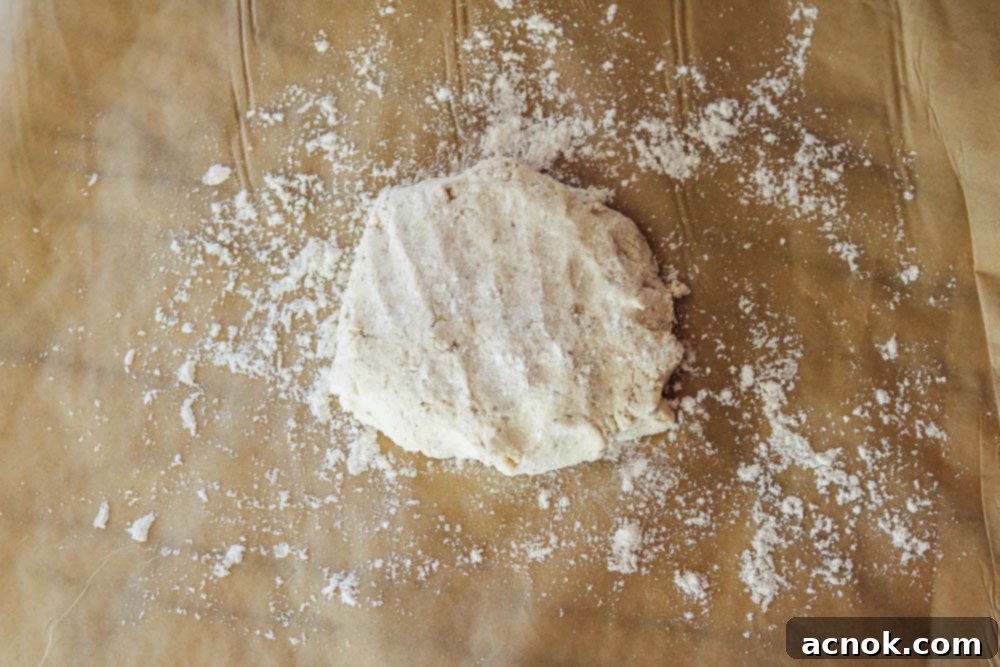 dough spread out on parchment paper