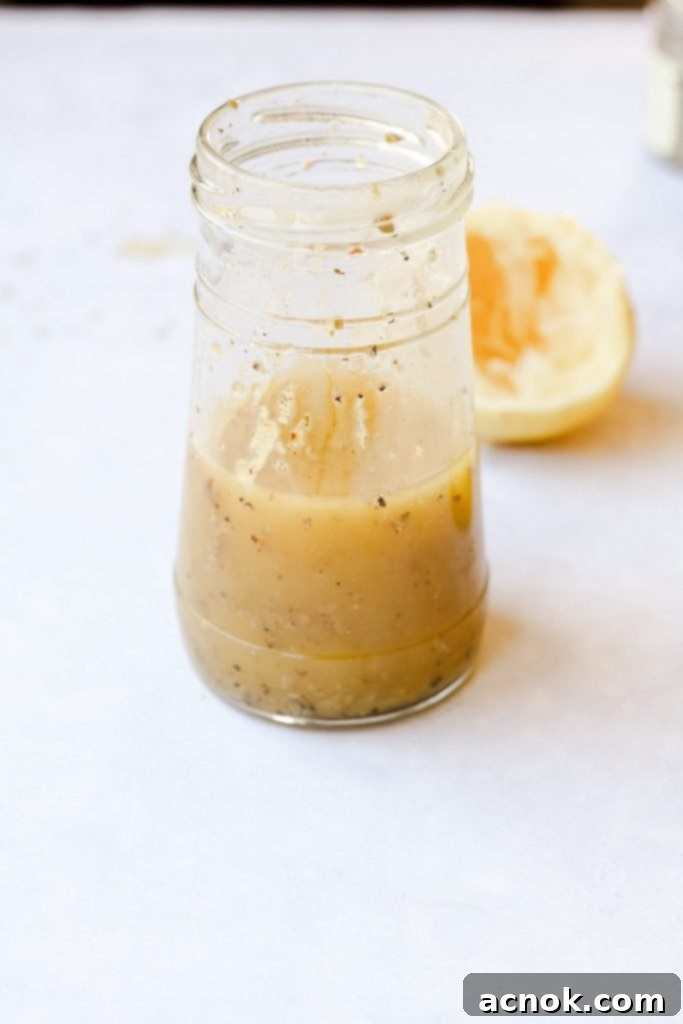 Freshly made oregano vinaigrette in a glass jar, ready for use