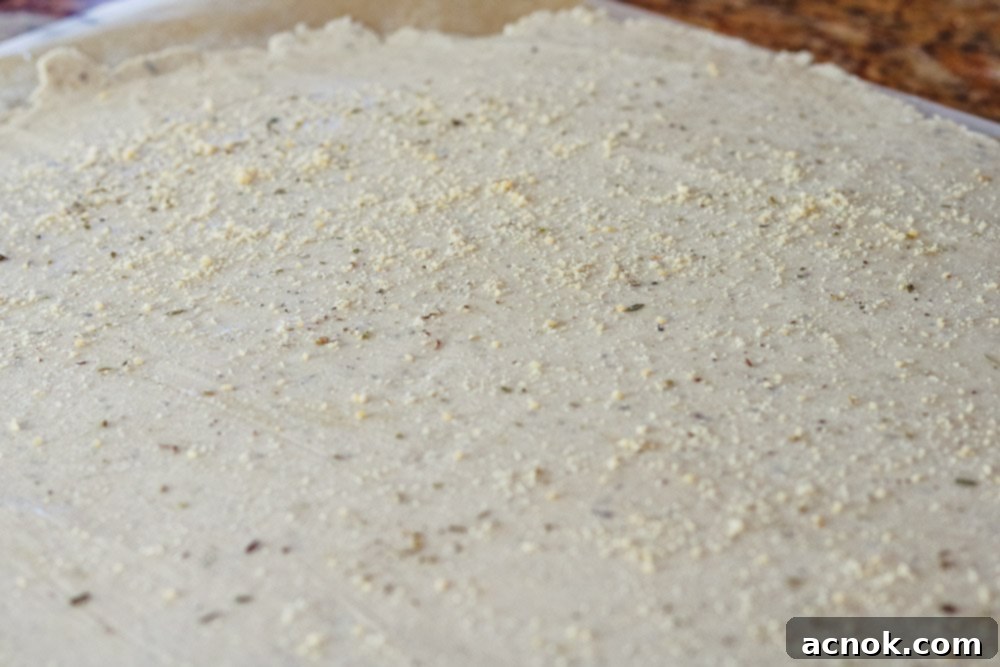 Close-up of gluten-free cracker dough with toppings before baking