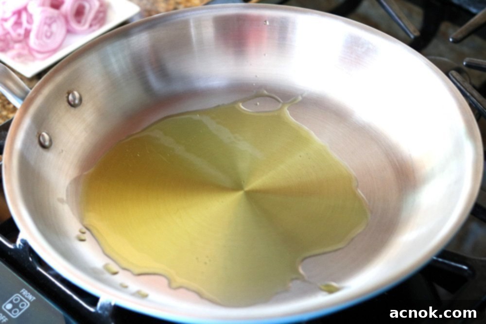 Olive oil heating in a non-stick skillet over low heat.