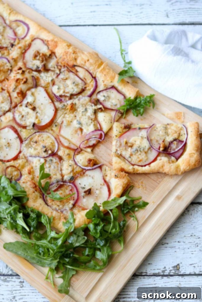 Puff pastry tart sliced into individual wedges, ready to be picked up and served.