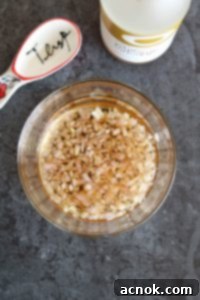 Minced shallot soaking in white balsamic vinegar in a bowl
