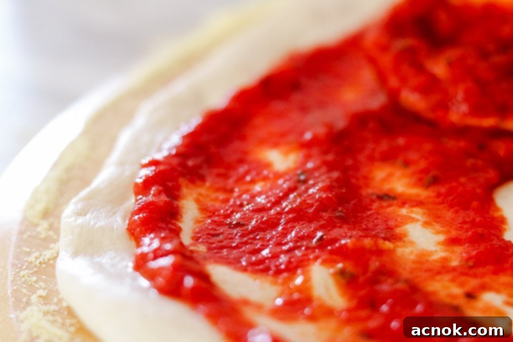 Delicious Rich and Zesty Pizza Sauce spread evenly on a fresh, ready-to-bake pizza dough, topped with pepperoni.