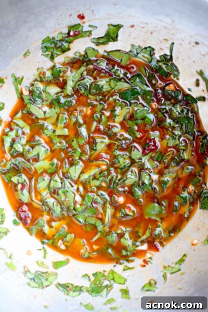 A bowl of freshly made red chimichurri sauce, vibrant and ready to use.