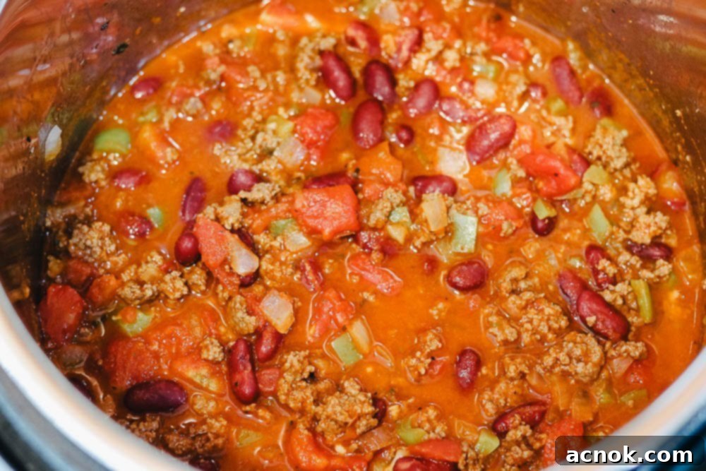 Close-up of freshly cooked beef chili bubbling in an Instant Pot after pressure release