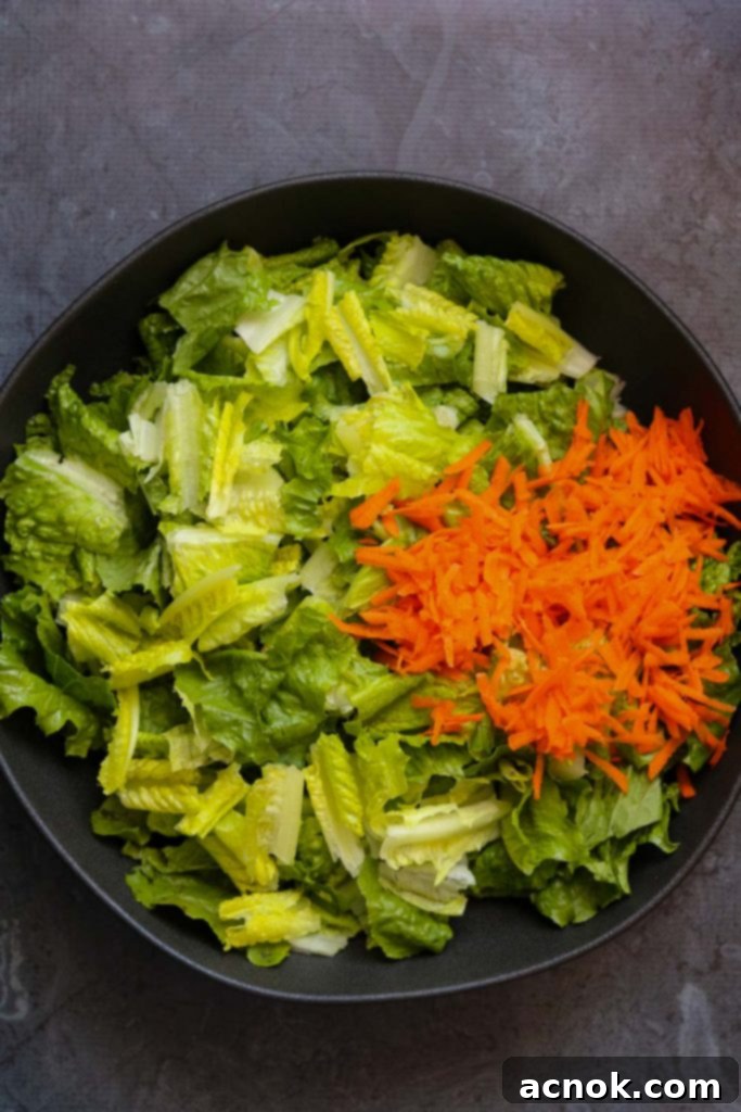 lettuce and carrots in black bowl