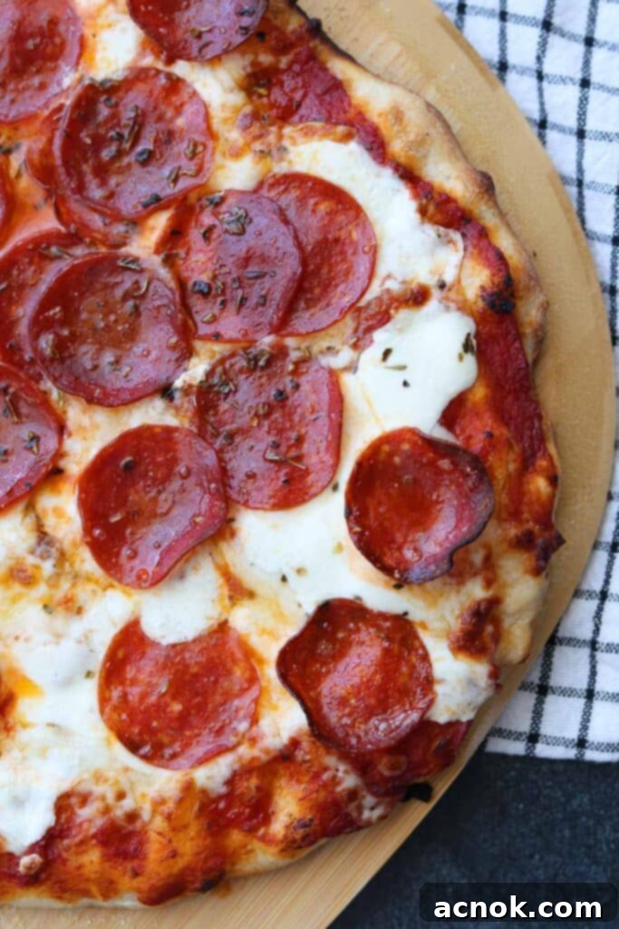 Perfect all purpose pizza dough pizza with extra pepperoni, showcasing a beautifully baked thin crust