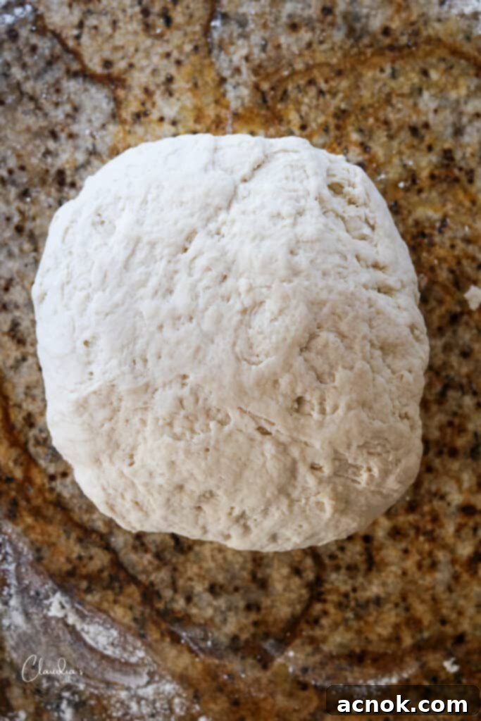 forming pizza dough into a smooth ball