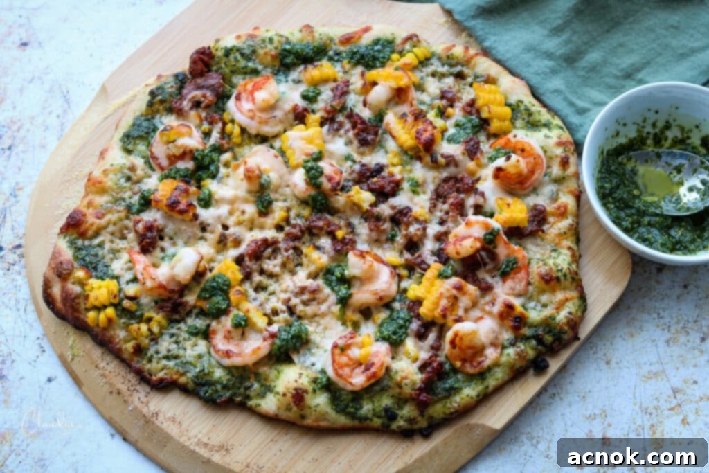 horizontal image of homemade chorizo and shrimp pizza with roasted jalapeño cilantro pesto