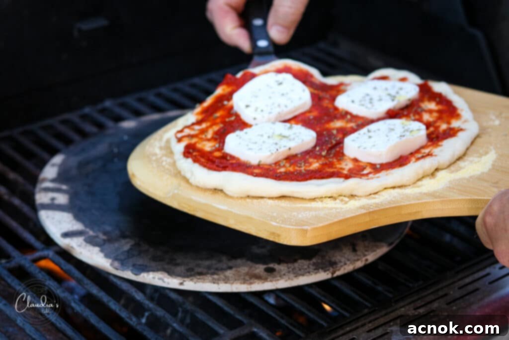 carefully placing pizza onto a hot pizza stone with a peel