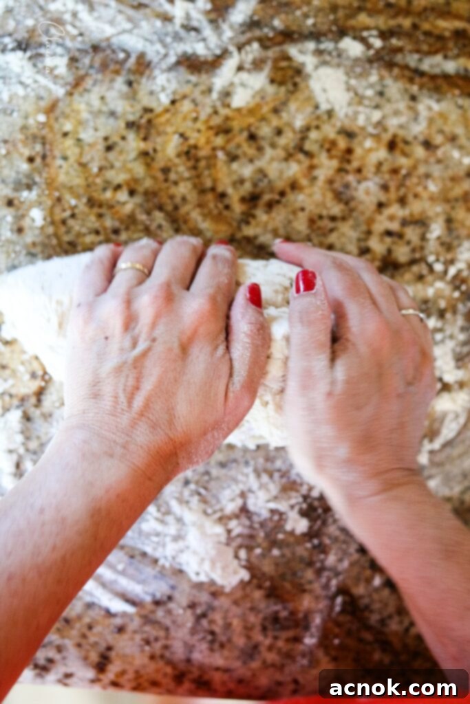 continuing to knead pizza dough for several minutes