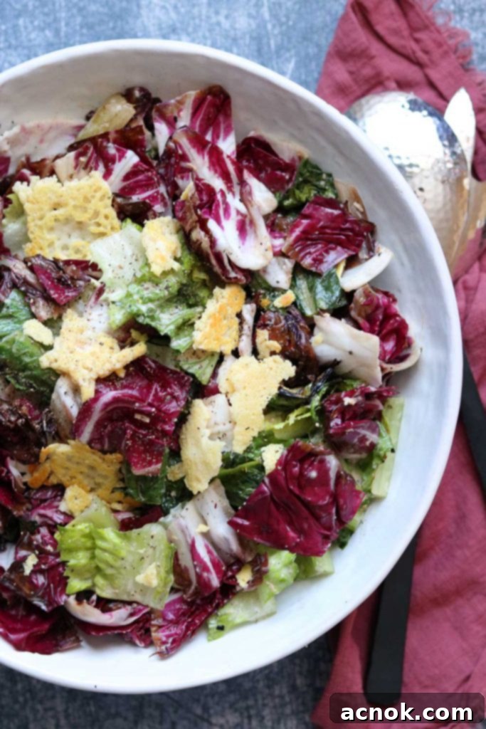 Smoky Grilled Romaine Radicchio Caesar 2 Plated Grilled Romaine and Radicchio Caesar Salad, garnished with Parmesan crisps and fresh black pepper