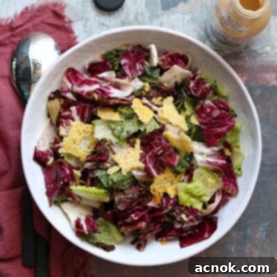Smoky Grilled Romaine Radicchio Caesar 9 Grilled Caesar salad in a rustic serving bowl, accompanied by serving tongs, a bottle of dressing, and fresh ingredients on the side